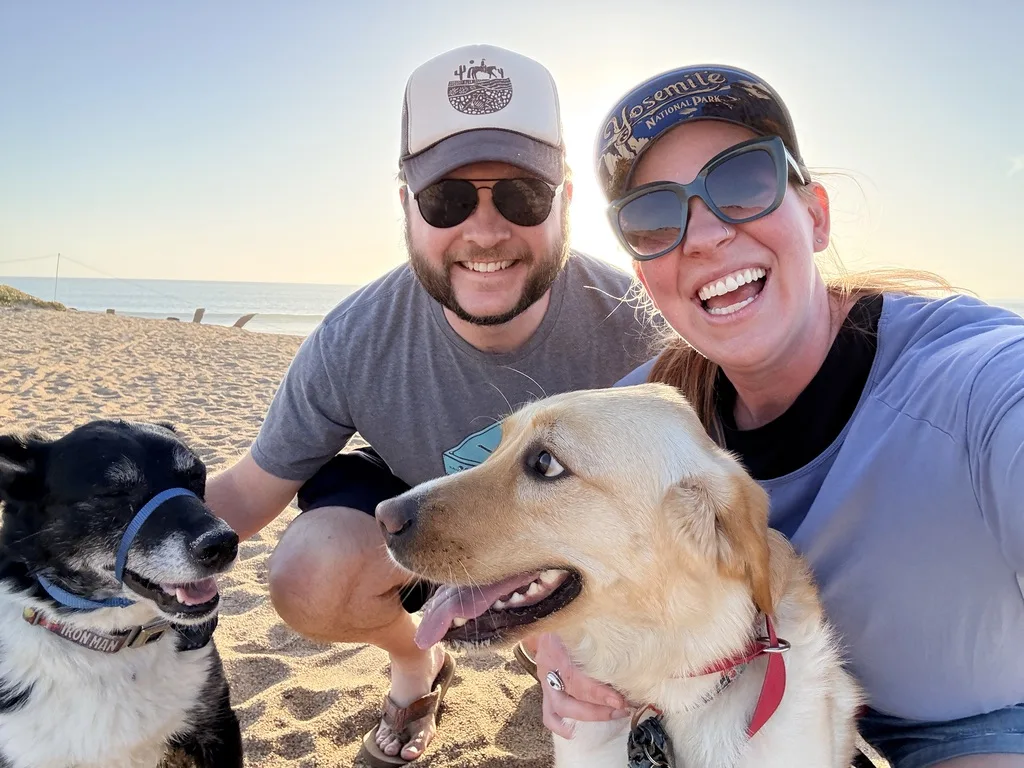 Matt and Rachel Audette on a beach with their dogs Tony and Poppy